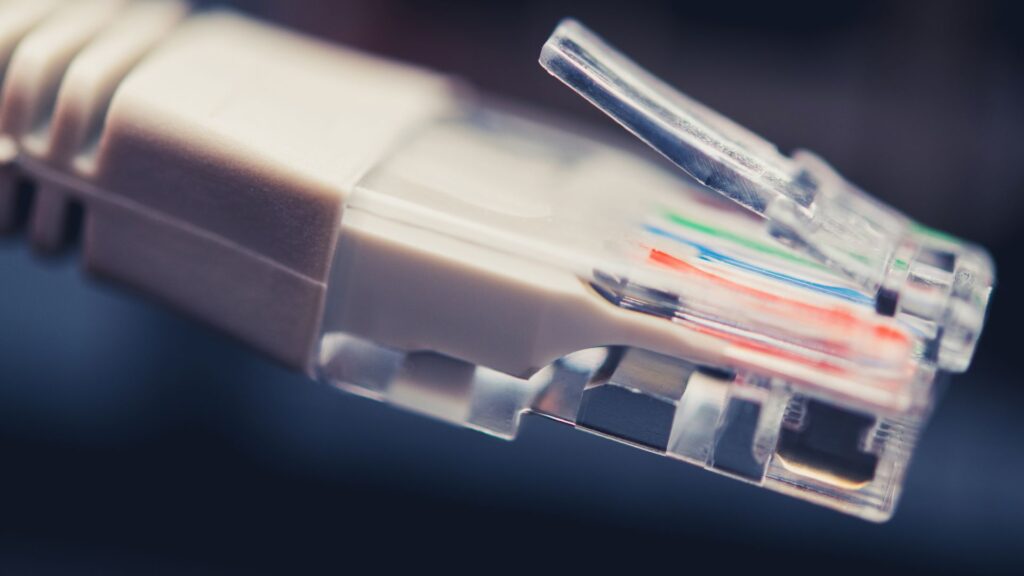 Close-up view of an Ethernet cable connector showing internal colored wires and the transparent plastic casing, often inspected when an Ethernet connection is not working on a Surface device.